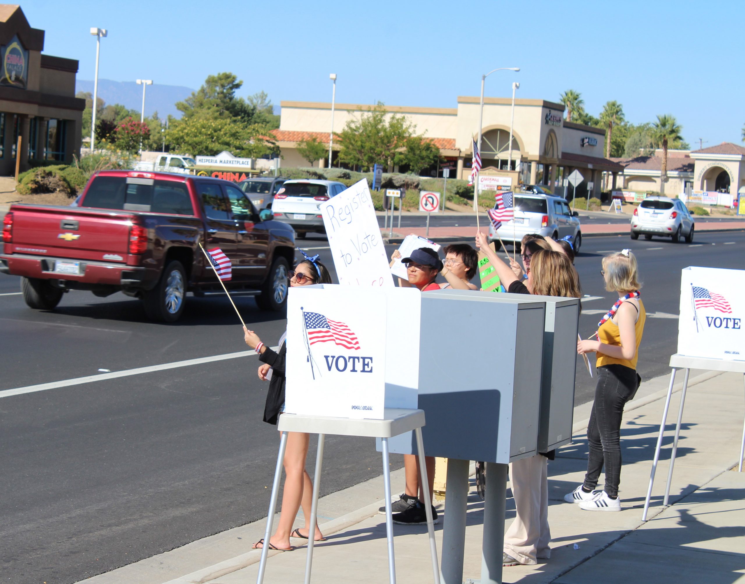 High School students promoting voter registration on the sidewalk