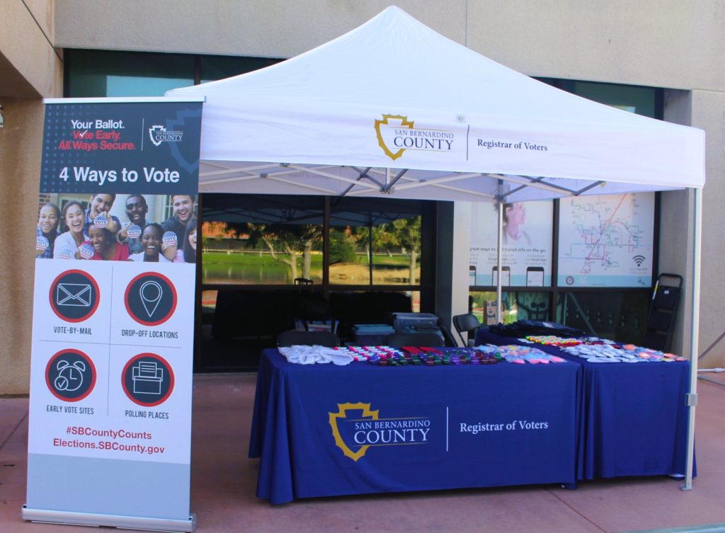 Tabling event with 4 ways to vote banner and giveways